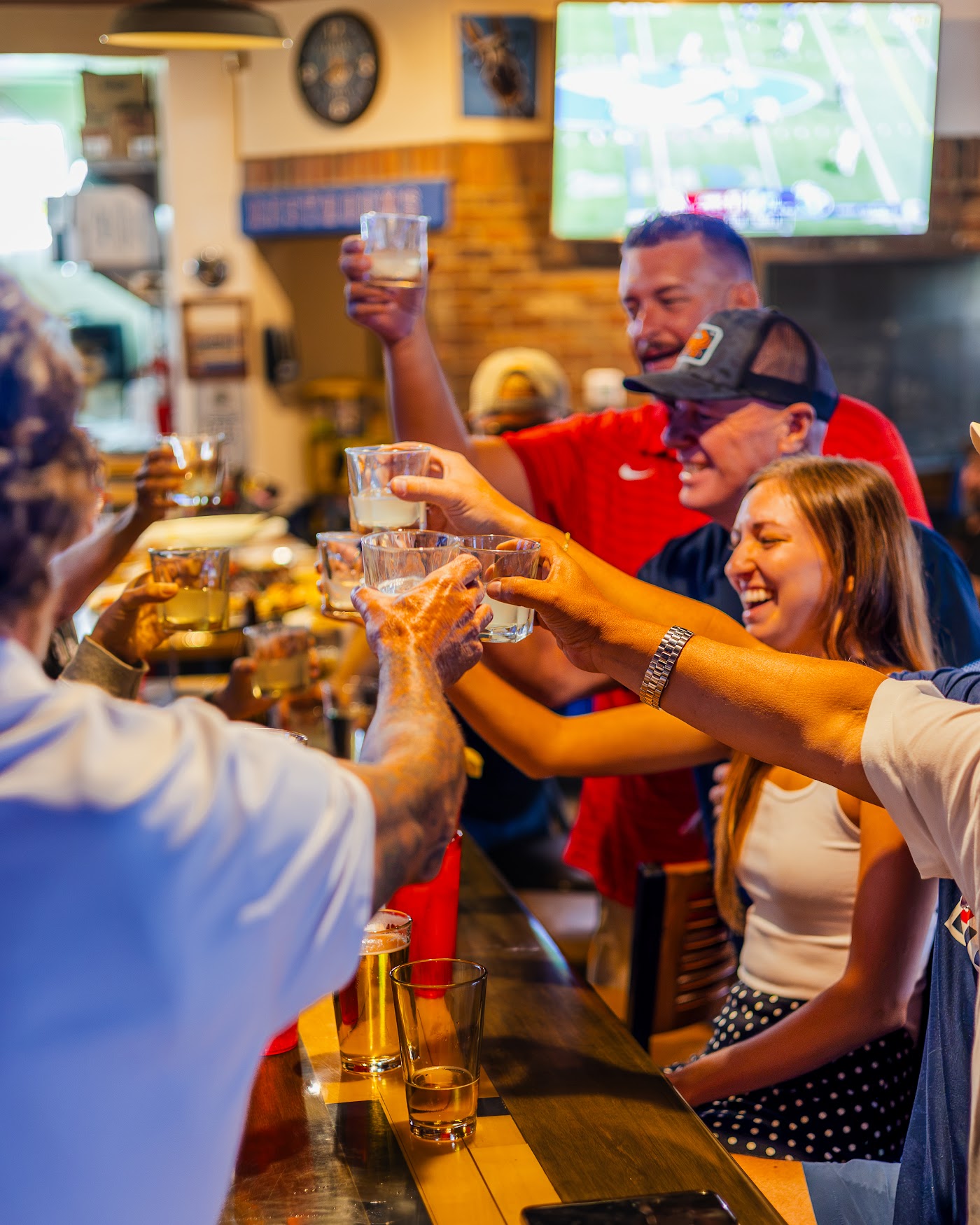 Staff and regulars cheering at the bar
