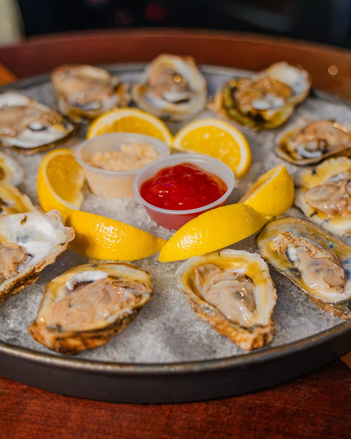 Platter of oysters on ice with lemon