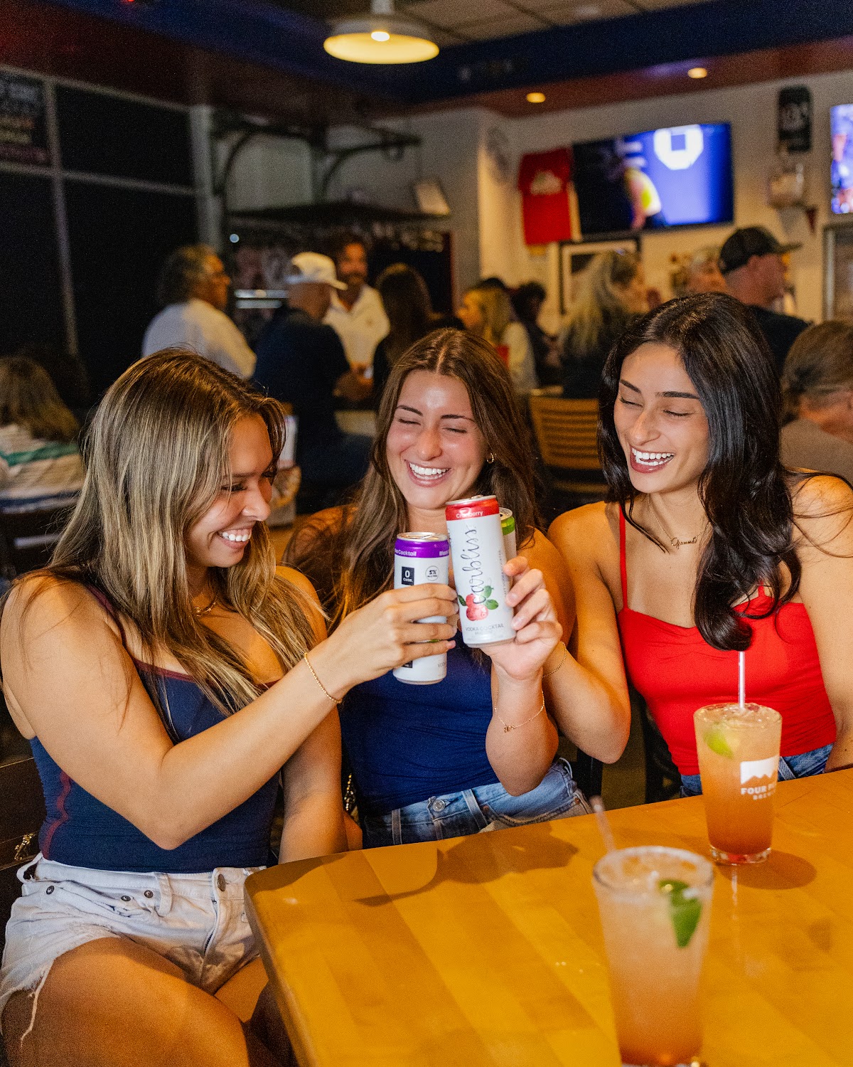 Friends cheersing at a Pizza Pub table