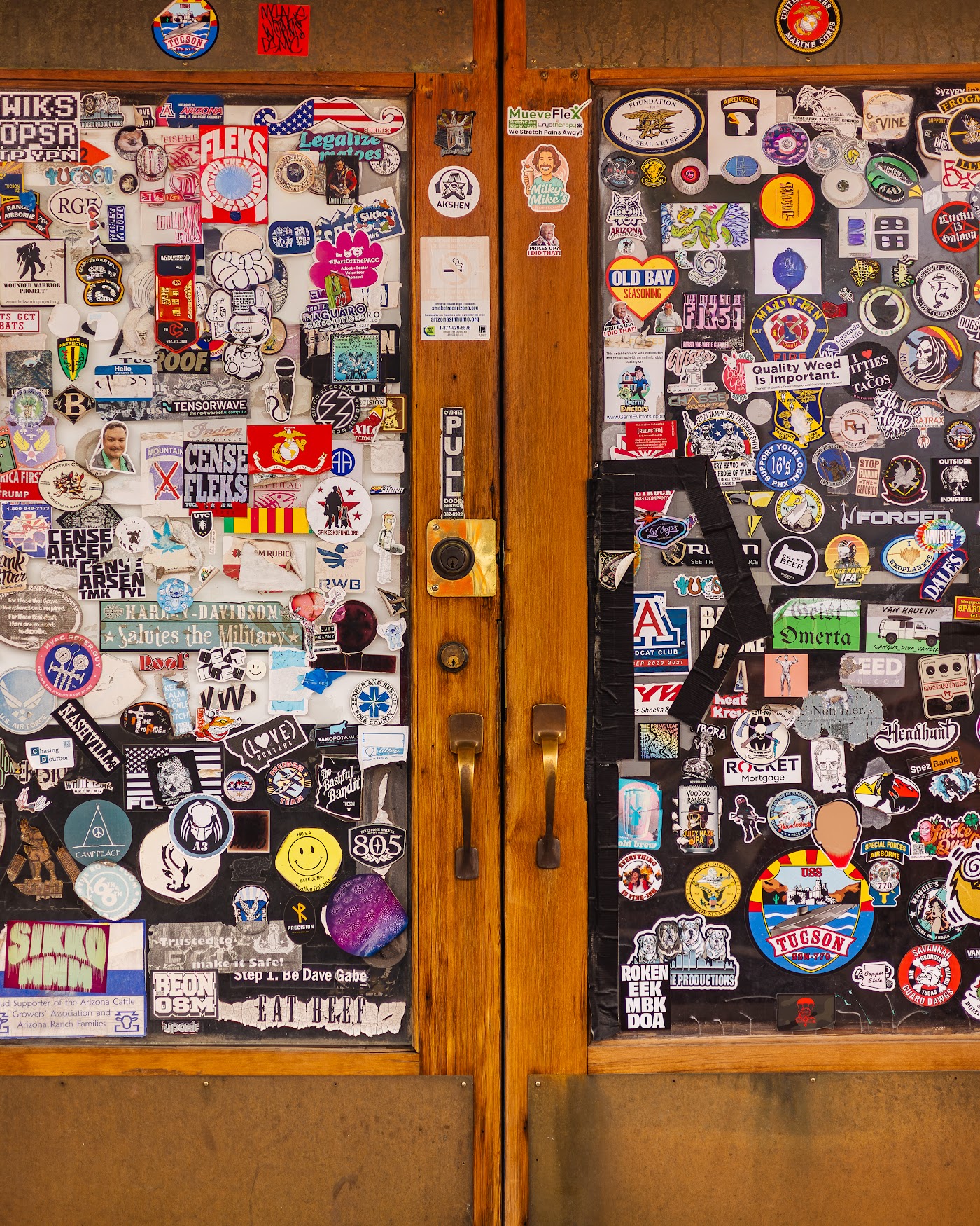 The Trident front door, covered in years of stickers